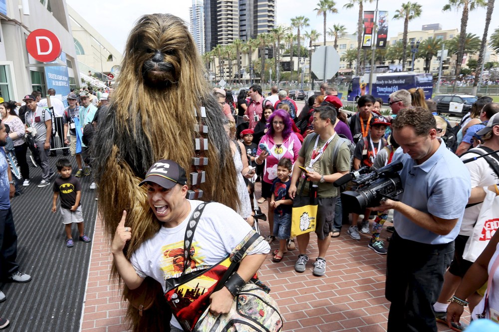 A man dressed as Chewbacca from Star Wars poses with fans outside of the 2015 Comic-Con International in San Diego, Calif. on July 9, 2015. (Photo by Sandy Huffaker/Reuters)