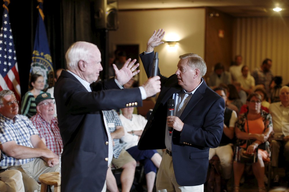 U.S. Republican presidential candidate Lindsey Graham gestures with Arizona Senator John McCain at a campaign town hall event in Manchester, N.H., Aug. 1, 2015. (Photo by Dominick Reuter/Reuters)