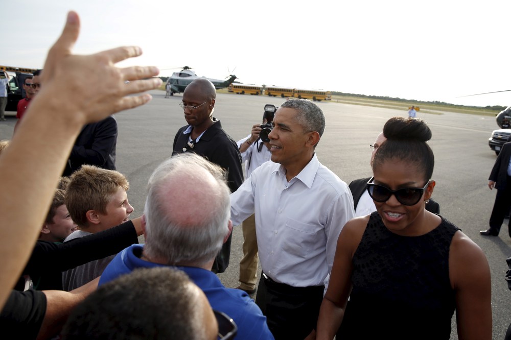 U.S. President Barack Obama and first lady Michelle Obama greet well wishers upon their arrival in Martha's Vineyard