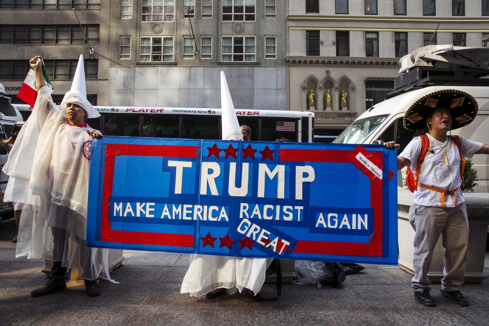 Demonstrators stand outside of Trump Towers to protest Donald Trump's candidacy for U.S. President in NY, Sept. 3, 2015.