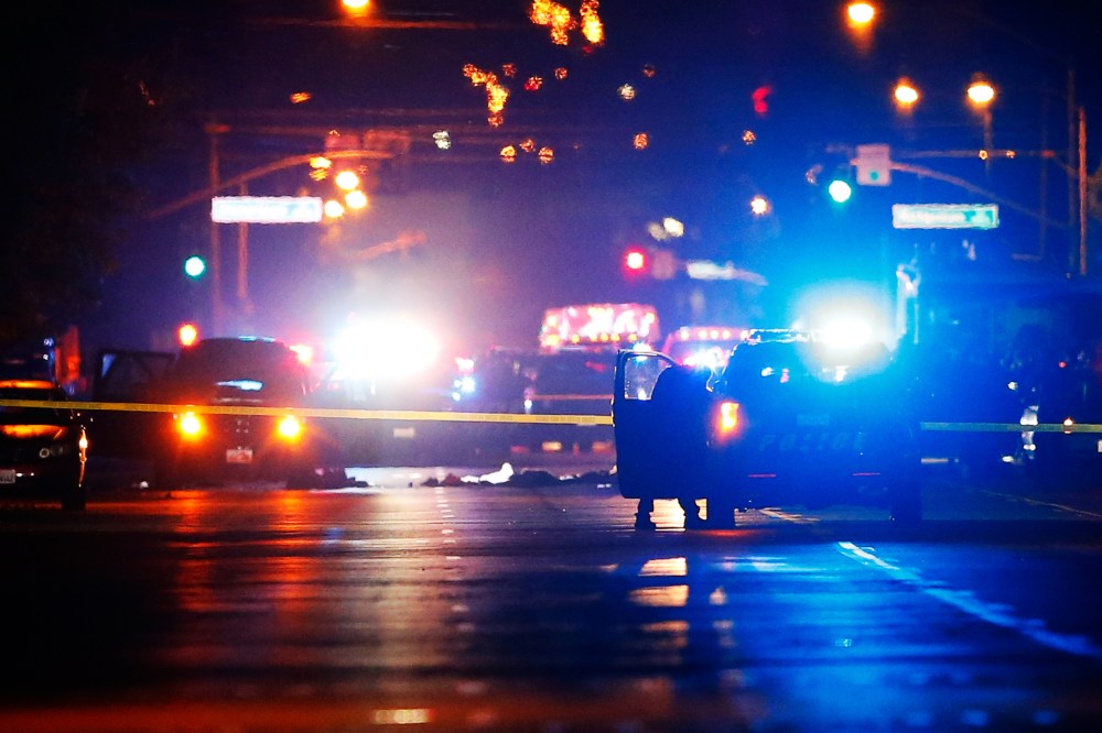 Police vehicles line the street around a vehicle in which two suspects were shot following a mass shooting in San Bernardino, Calif., Dec. 2, 2015. (Photo by Mike Blake/Reuters)