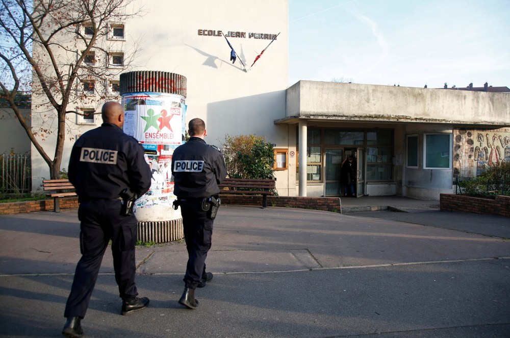 French police stand in front of the nursery school where a teacher claimed to have been assaulted by a hooded man with a knife, reportedly acting for Islamic State in Aubervilliers, near Paris, France, Dec. 14, 2015. (Photo by Charles Platiau/Reuters)