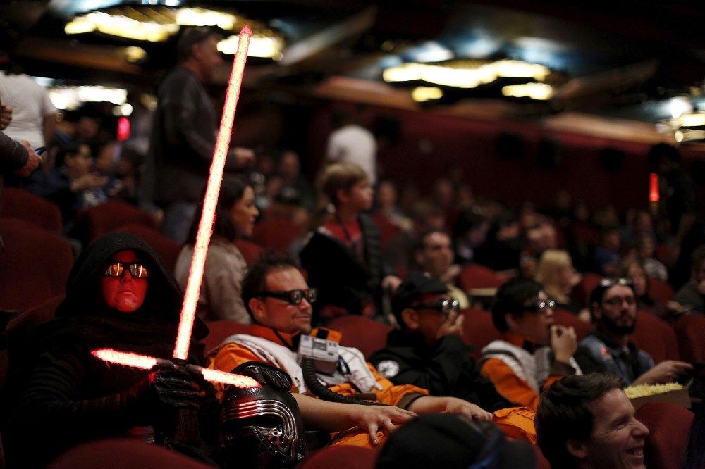 Moviegoers Dawn and Daniel Bright sit before the first showing of the movie "Star Wars: The Force Awakens" at the TCL Chinese Theatre in Hollywood, Calif., Dec. 17, 2015. (Photo by Mario Anzuoni/Reuters)