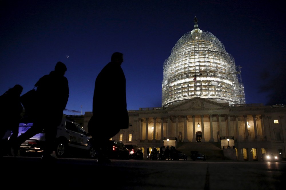 People walk past the U.S. Capitol dome in the hours before President Barack Obama delivers the State of the Union address to a joint session of Congress in Washington, Jan. 12, 2016. (Photo by Jonathan Ernst/Reuters)