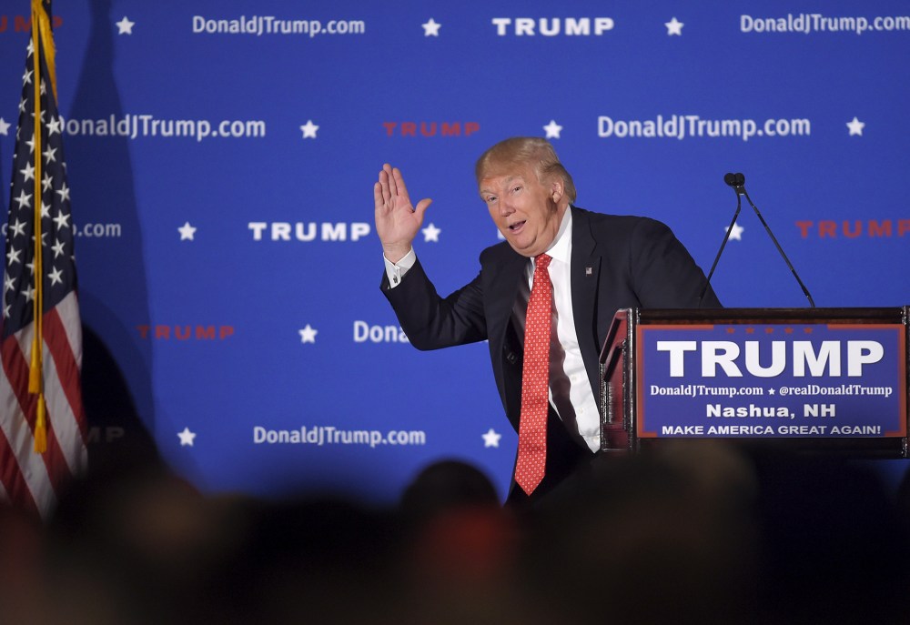 U.S. Republican presidential candidate Donald Trump pantomimes a candidate with low poll numbers as he address the audience at a campaign rally in Nashua, N.H., Jan. 29, 2016. (Photo by Gretchen Ertl/Reuters)