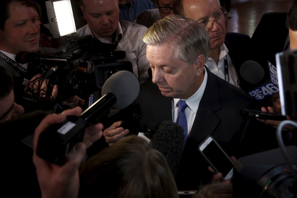 Senator Lindsey Graham is surrounded by reporters outside a Republican presidential candidates debate in Greenville, S.C., Feb. 13, 2016. (Photo by Jonathan Ernst/Reuters)