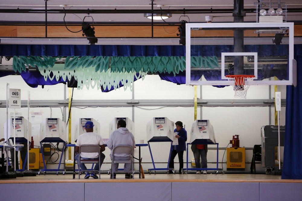 Voters use booths located on the stage at the polling center at the James Weldon Johnson Community Center during the New York primary elections in East Harlem, New York City, April 19, 2016. (Photo by Andrew Kelly/Reuters)