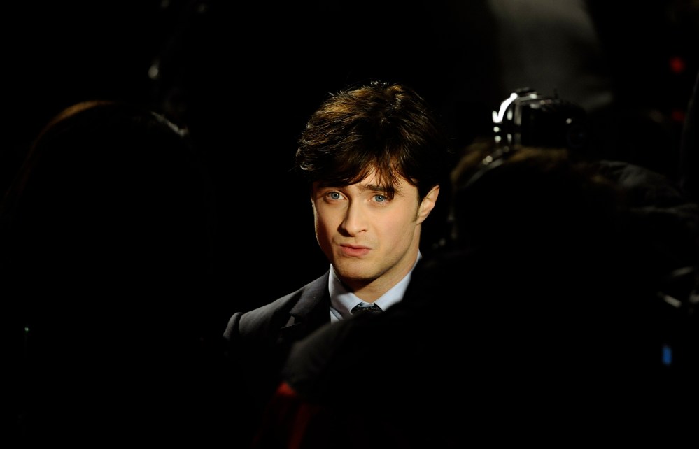 Britain's Daniel Radcliffe is seen posing as he arrives for the world premiere of "Harry Potter and the Deathly Hallows: Part 1" at Leicester Square in London, Nov. 11, 2010. (Photo by Dylan Martinez/Reuters)