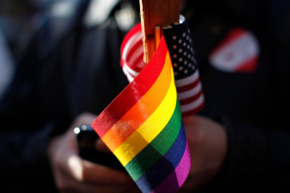 The gay pride and American flag are seen at a demonstration. (Photo by Stephen Lam/Reuters)