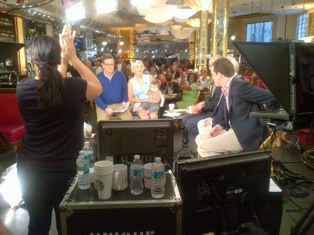 Floor director Jen Lipman cues audience members, some of whom drove as long as two hours to get seated and served in time for 