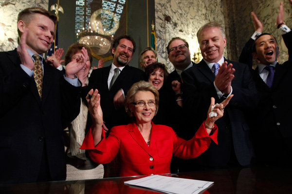 Gov. Christine Gregoire surrounded by supporters after signing a bill that legalizes same-sex marriage in Olympia, Washington on Monday.