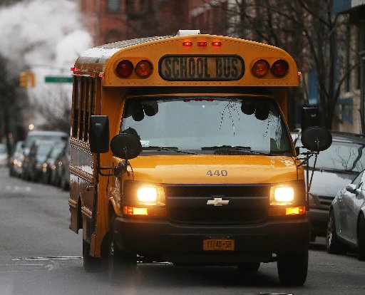 A school bus drives down a street in Manhattan's East Village on January 15, 2013 in New York City. (Photo by Mario Tama/Getty Images)