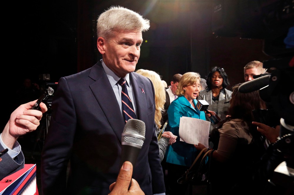 Senate candidate, Rep. Bill Cassidy, left, talks to the media in Shreveport, La. on Oct. 14, 2014.