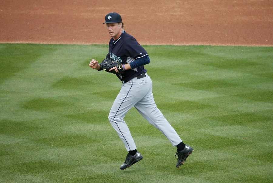 Actor Will Ferrell runs to the dugout after playing second base for the Seattle Mariners during the second inning of a spring training baseball game against the Oakland Athletics, on March 12, 2015, in Mesa, Ariz.