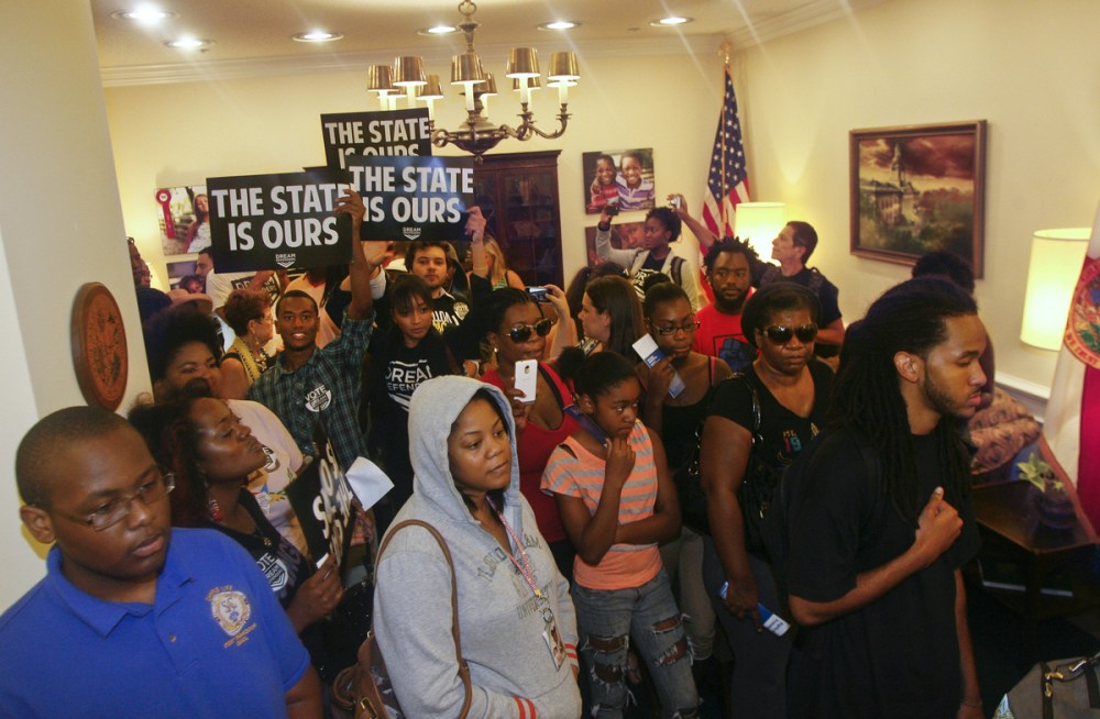 Protesters crowd into Florida Gov. Rick Scott's office Tuesday July 16, 2013, at the Capitol in Tallahassee, Fla. Dream Defenders organized a sit-in of Florida Gov. Rick Scott's office in response to the not guilty verdict in the trial of George...