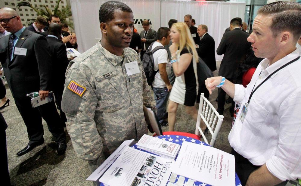 Matthew Desrosiers, right, of the Manhattan Vet Center, confers with Eric Jones, of Clevelend, during the Hiring Our Heroes job fair, part of the second annual VOWS Conference on Veteran Joblessness in New York, Thursday, June 21, 2012.