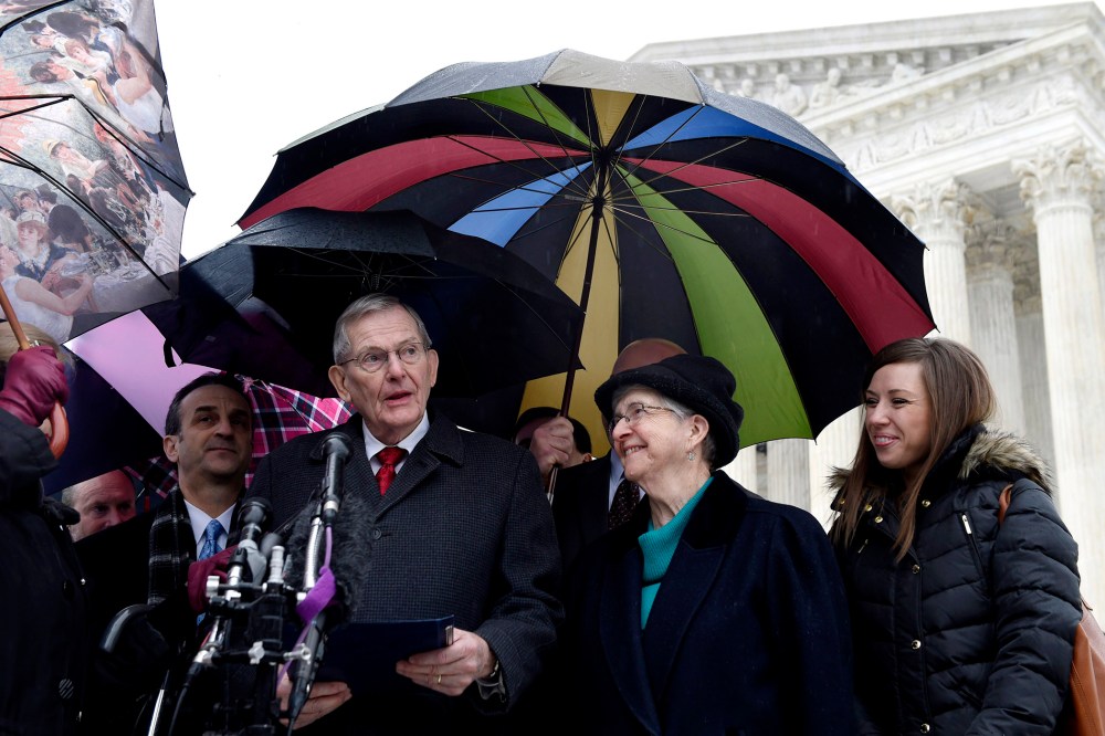 Good News Community Church Pastor Clyde Reed, center, accompanied by his wife, speaks to reporters outside the Supreme Court in Washington, on Jan. 12, 2015.