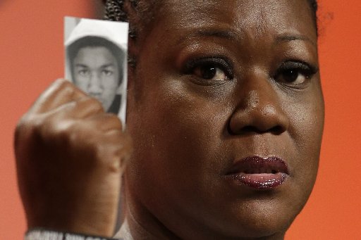Sybrina Fulton, mother of Trayvon Martin, holds up a card with a photo of her son as she speaks at the National Urban League's annual conference, Friday, July 26, 2013, in Philadelphia. Fulton told the National Urban League gathering to use her story,...