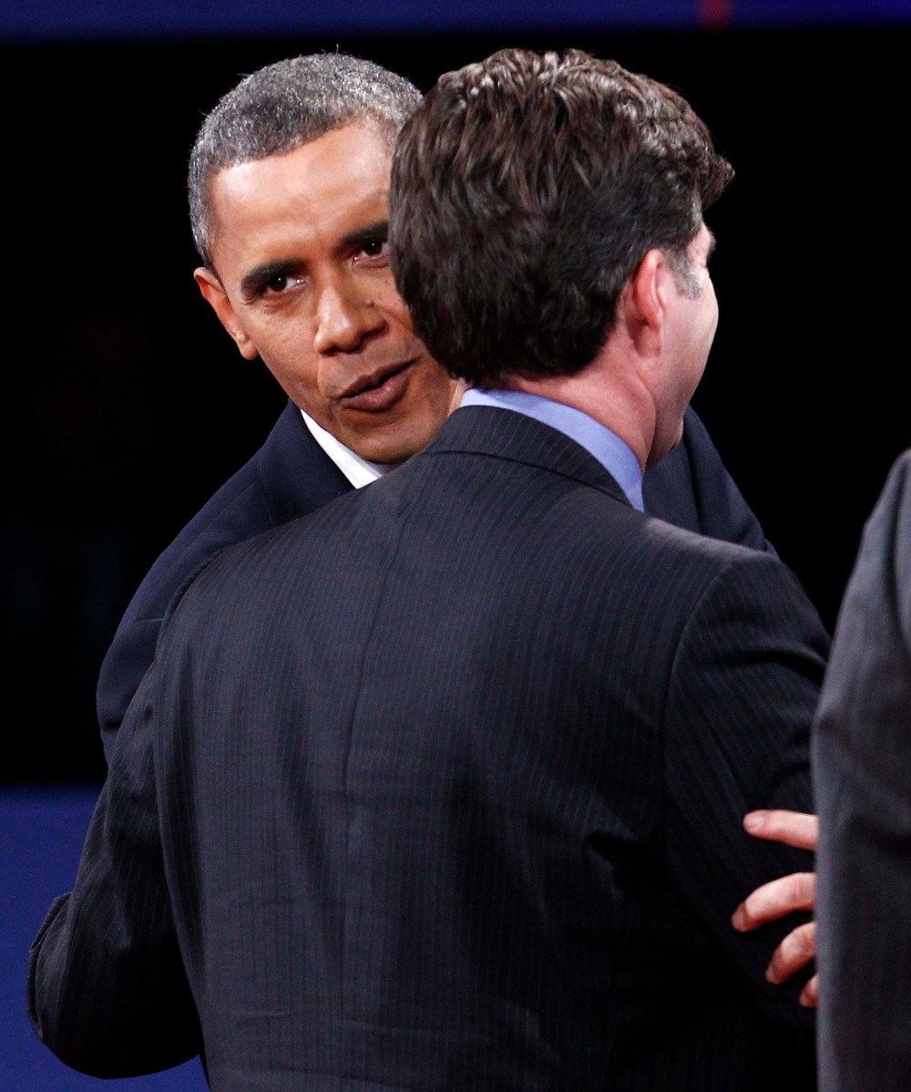 Forgive and forget? President Obama whispers into Tagg Romney's ear after the final presidential debate on Monday. (Photo: REUTERS/Jim Young)