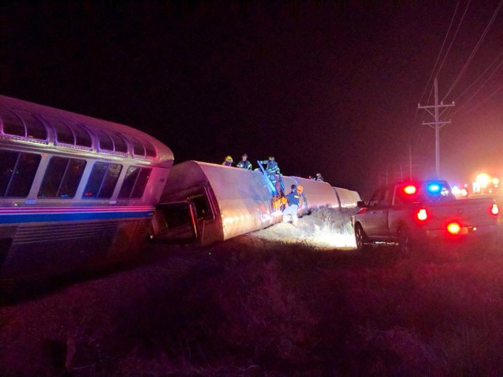 Emergency personnel work on a train that derailed near Dodge City, Kan., March 14, 2016. (Photo by Daniel Szczerba/AP)
