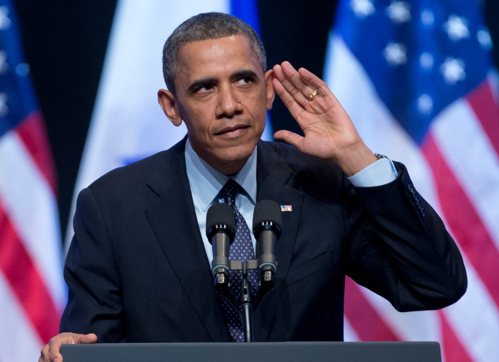 President Barack Obama looks into the crowd and tries to hear a person yelling at him during his speech at the International Convention Center in Jerusalem, Thursday, March 21, 2013. (Photo by Carolyn Kaster/AP)