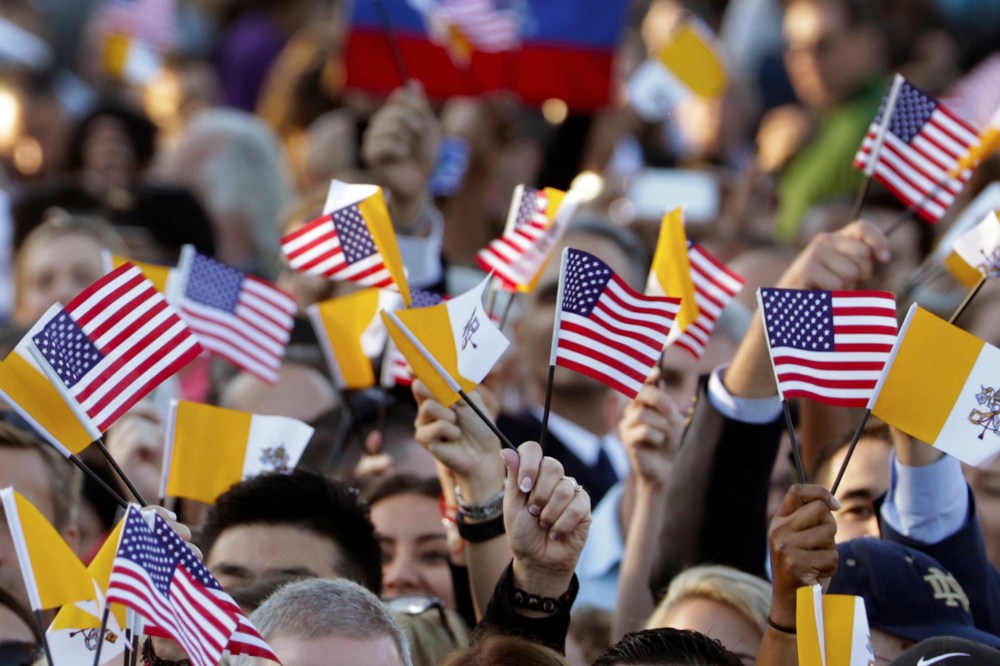 Spectators hoping for a glimpse of Pope Francis waves Papal and U.S. Flags on the South Lawn of the White House in Washington, D.C., Sept. 23, 2015. (Photo by Pablo Martinez Monsivais/AP)
