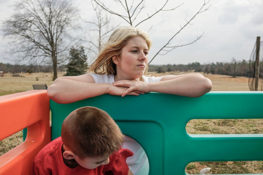 Stormy Davidson with her son Aiden playing in Rattan, Okla.  She, and her husband Glen Davidson were teenagers when she got pregnant.