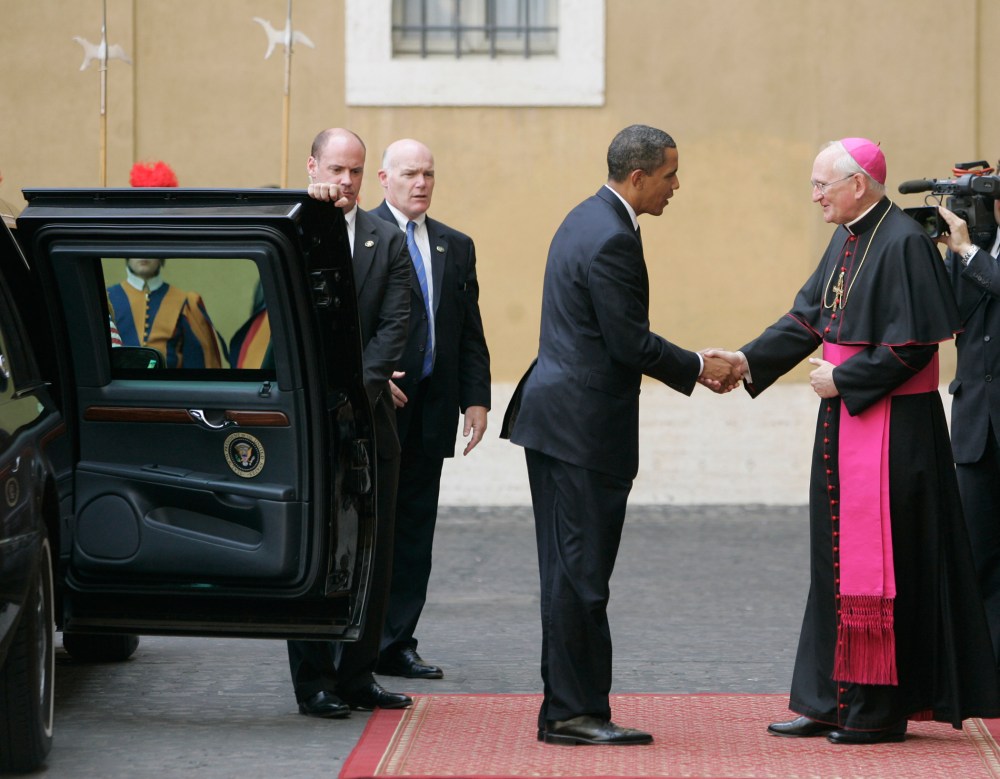 President Barack Obama is welcomed by Bishop James Harvey, at right, as he arrives at the Vatican for a meeting with Pope Benedict XVI, Friday July 10, 2009.