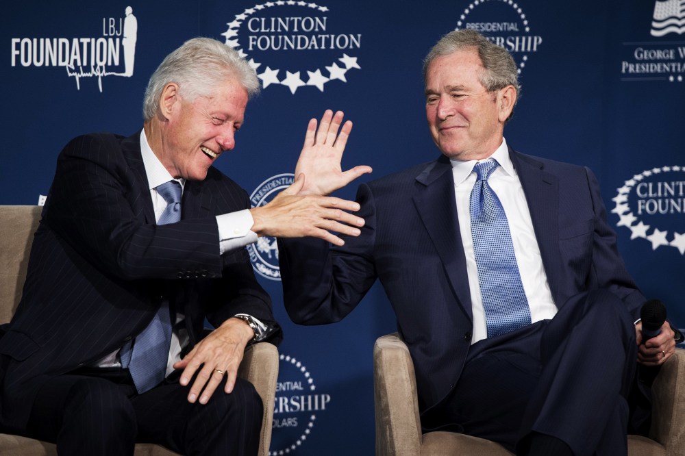 Bill Clinton and George W. Bush shake hands during the launch of the Presidential Leadership Scholars Program in Washington, DC, September 8, 2014.