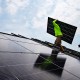 Nicholas Hartnett, owner of Pure Power Solar, carries a panel as he and Brian Hoeppner install a solar array on the roof of a home in Frankfort, Ky., on July 17, 2023.