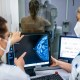 Medical personnel use a mammogram to examine a woman's breast for breast cancer.