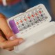 Teenage Girl Holding Birth Control Pills