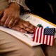 A new citizen holds an American flag during a naturalization ceremony