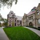A passer-by walks along a path on the campus of Brown University