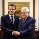 Image: French President Emmanuel Macron shakes hands with Palestinian President Mahmoud Abbas