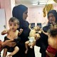 Mothers hold their emaciated children at Nasser Hospital in Khan Yunis, Gaza