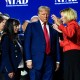 President Donald Trump prays with Pastor Paula White and other faith leaders