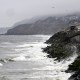 The Pacific Ocean along coastline as a wave crashes onto the land