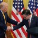 President Donald Trump and House Speaker Mike Johnson shake hands at a reception at the White House