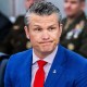 Pete Hegseth looks on during a meeting.