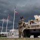 National Guard troops and a humvee next to Union Station, with American flags.