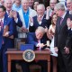 President Donald Trump pounds a gavel presented to him by House Speaker Mike Johnson