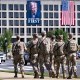National Guard soldiers patrol on Aug. 26, 2025, in front of a banner of President Donald Trump on the Department of Labor in Washington.