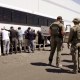 Manufacturing plant employees waiting to have their legs shackled at the Hyundai Motor Group’s electric vehicle plant on Sept. 4, 2025, in Ellabell, Ga.
