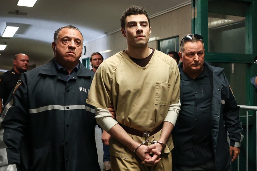 Luigi Mangione, accused of the murder of United Healthcare CEO Brian Thompson, is escorted by police as he arrives at court in New York City on September 16, 2025.