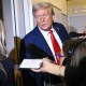 President Donald Trump speaks to reporters while in flight on Air Force One, en route Joint Base Andrews on September 21, 2025.