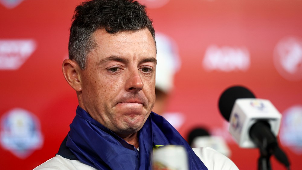 Rory McIlroy sits in front of a microphone.