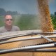 Mark German loads soybeans from grain bins into a truck