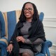 Ketanji Brown Jackson smiles while seated on a blue chair