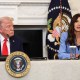 U.S. Secretary of Homeland Security Kristi Noem (R) speaks as U.S. President Donald Trump listens.